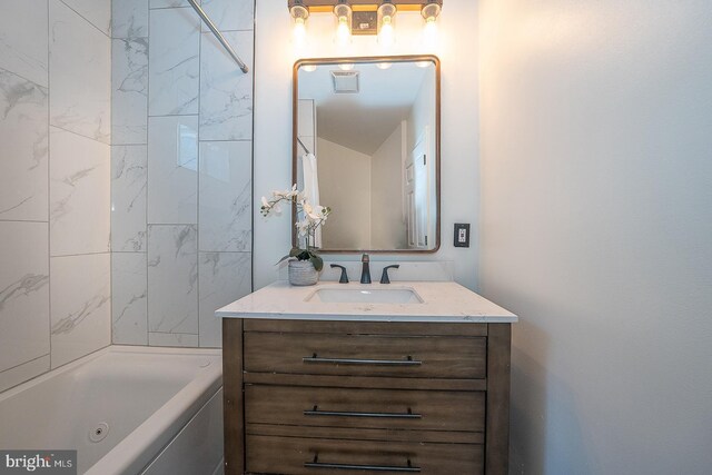 bathroom featuring vanity and tiled shower / bath combo