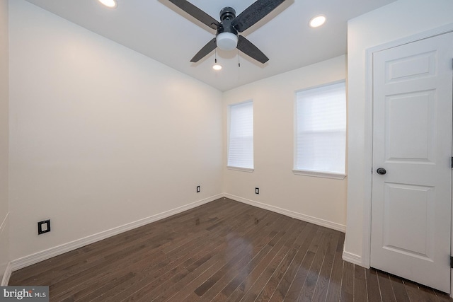 spare room featuring dark hardwood / wood-style flooring and ceiling fan