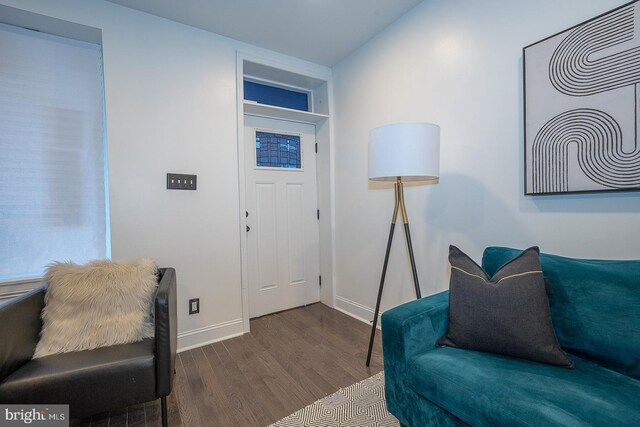 living area featuring hardwood / wood-style flooring and built in features