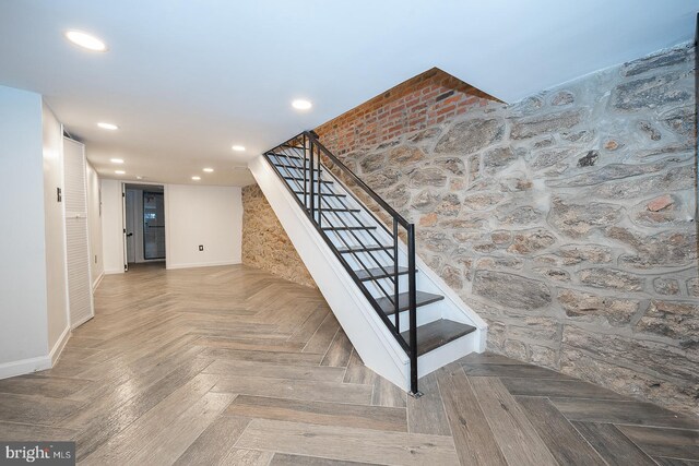 staircase featuring parquet floors