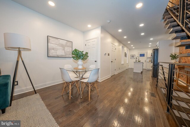 dining area with dark hardwood / wood-style flooring