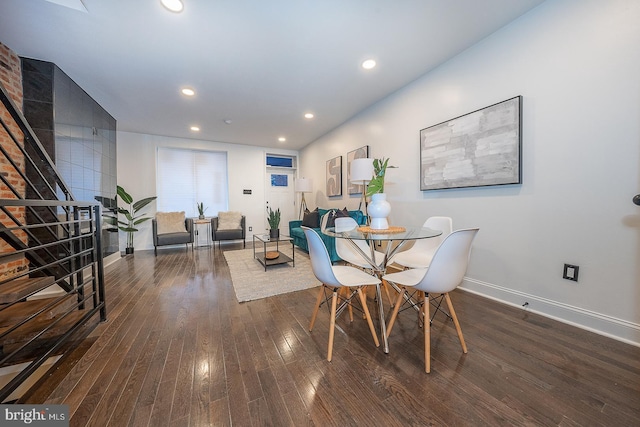 dining space with dark hardwood / wood-style flooring