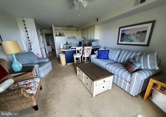 living room with light carpet and ceiling fan