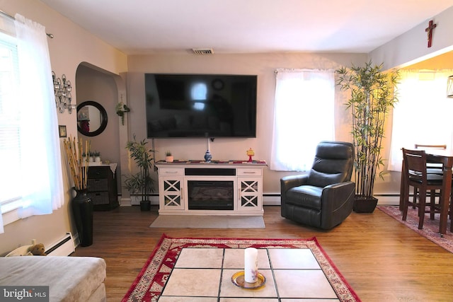 living room with hardwood / wood-style flooring and a baseboard radiator