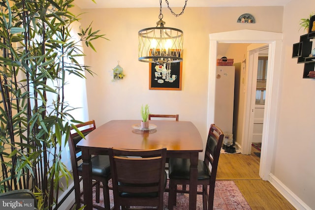 dining space with a chandelier and hardwood / wood-style flooring