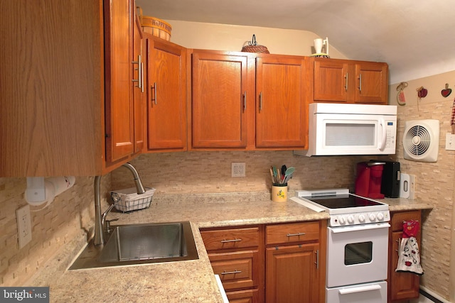 kitchen featuring white appliances, tasteful backsplash, and sink