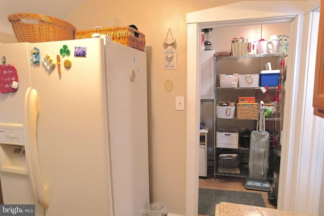 kitchen with white refrigerator with ice dispenser