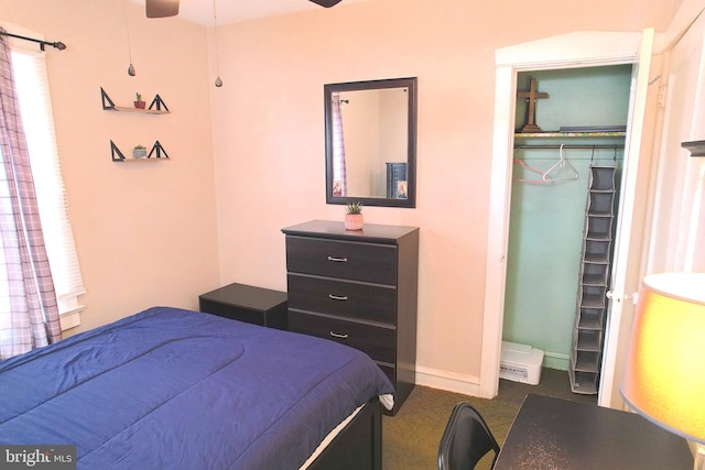 carpeted bedroom featuring ceiling fan and a closet