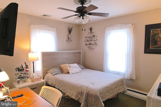 bedroom featuring multiple windows, a baseboard radiator, and ceiling fan