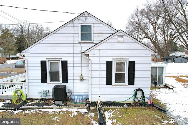 snow covered property featuring cooling unit