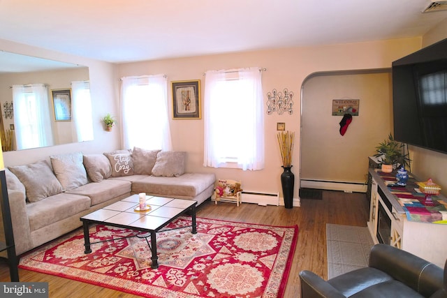 living room with hardwood / wood-style floors and a baseboard heating unit