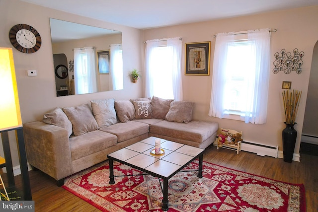 living room with a baseboard radiator and dark wood-type flooring