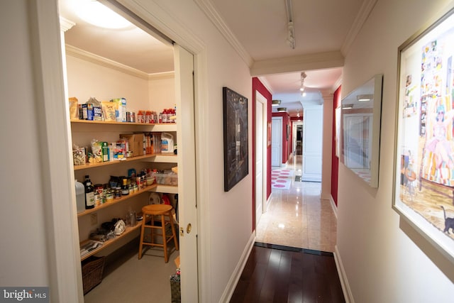 corridor with wood-type flooring, track lighting, and crown molding