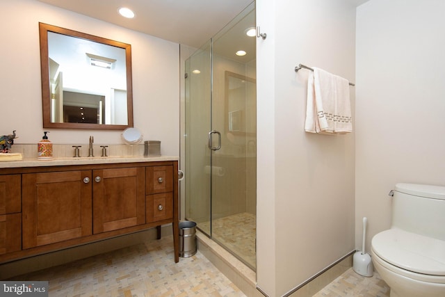 bathroom featuring walk in shower, vanity, and toilet