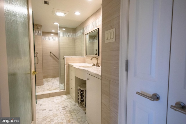 bathroom featuring vanity, tile patterned floors, and an enclosed shower