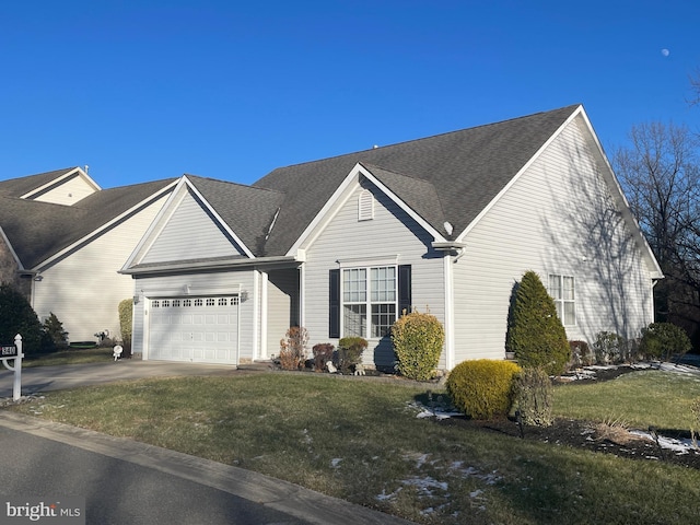 view of front of property featuring a garage and a front lawn