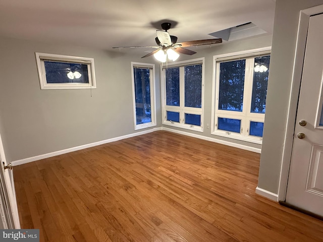 spare room with hardwood / wood-style floors and ceiling fan