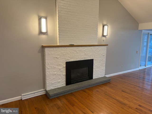 details featuring wood-type flooring, a baseboard radiator, and a brick fireplace