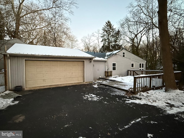 exterior space with a wooden deck and a garage