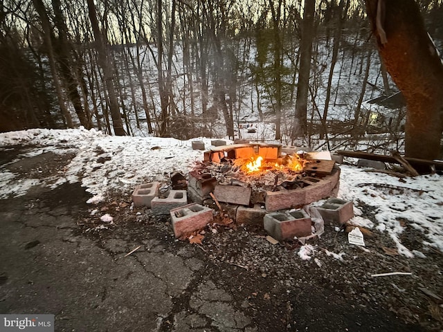 snowy yard with a fire pit