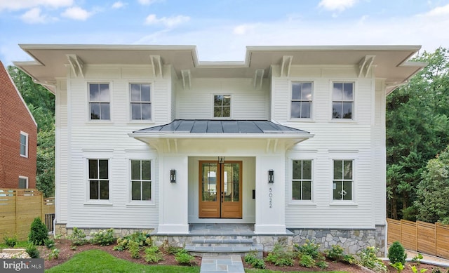 view of front of home featuring covered porch and french doors