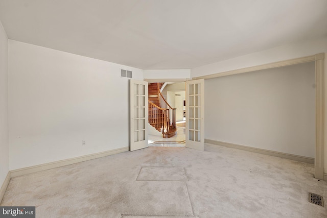 unfurnished room with carpet flooring and french doors