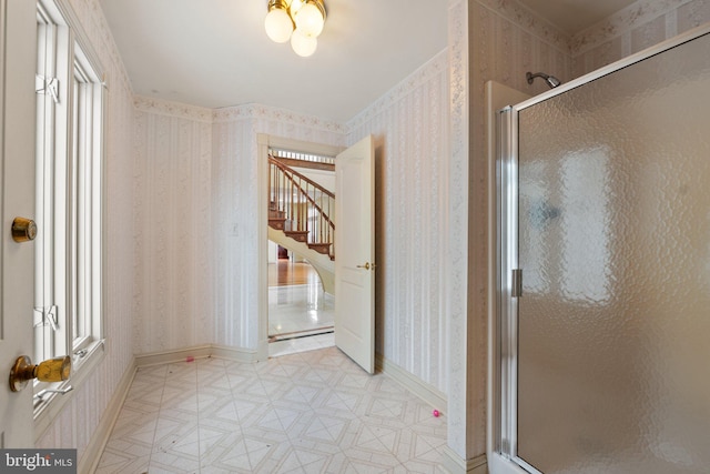 bathroom with a shower with door