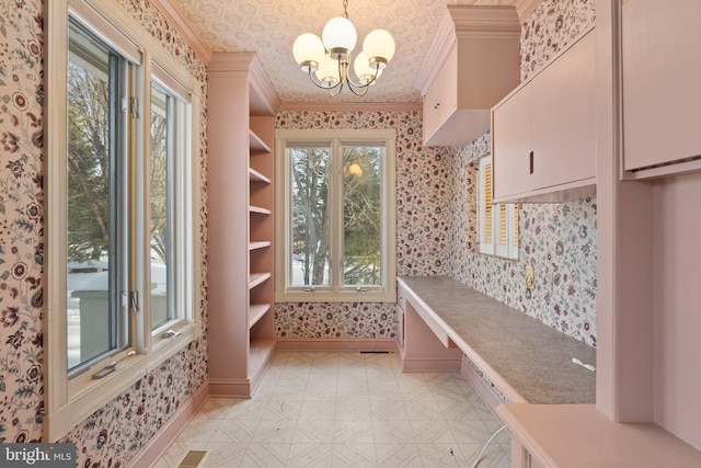 mudroom with a chandelier and ornamental molding