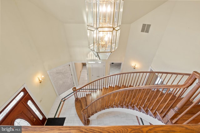 staircase featuring a notable chandelier