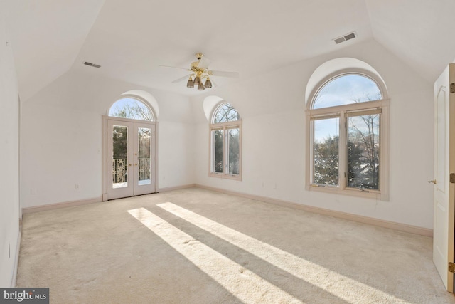 unfurnished room with french doors, light colored carpet, vaulted ceiling, and ceiling fan