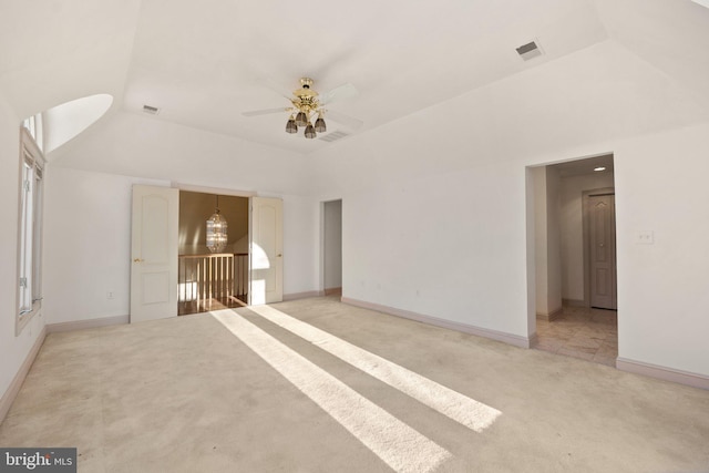 interior space featuring ceiling fan with notable chandelier, light carpet, and high vaulted ceiling