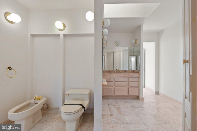 bathroom with vanity, a bidet, and toilet