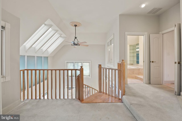 interior space featuring light colored carpet and vaulted ceiling