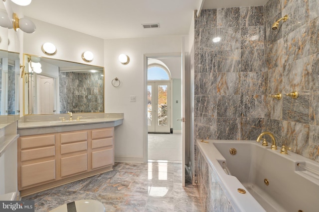 bathroom featuring vanity and tiled shower / bath combo