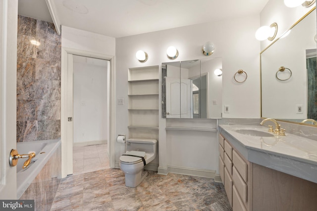 bathroom featuring tiled bath, vanity, and toilet