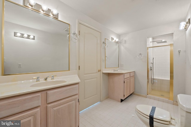 bathroom with vanity, toilet, and a shower with shower door