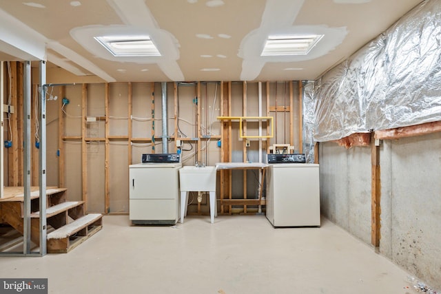 basement with separate washer and dryer and sink