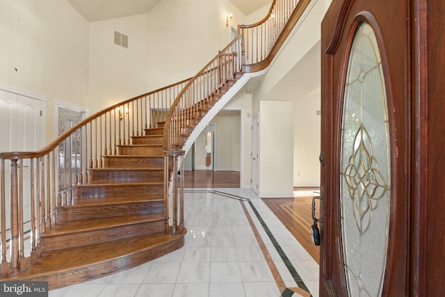 foyer entrance featuring a towering ceiling