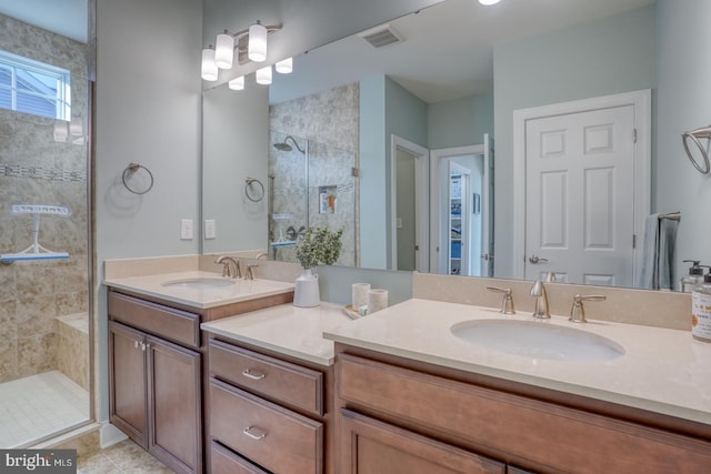 bathroom with tile patterned flooring, a shower with shower door, and vanity