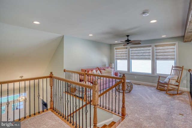 stairway with ceiling fan and carpet flooring