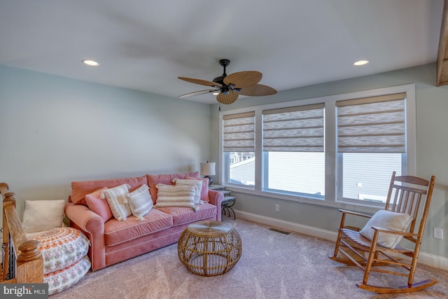 living room featuring ceiling fan and light colored carpet