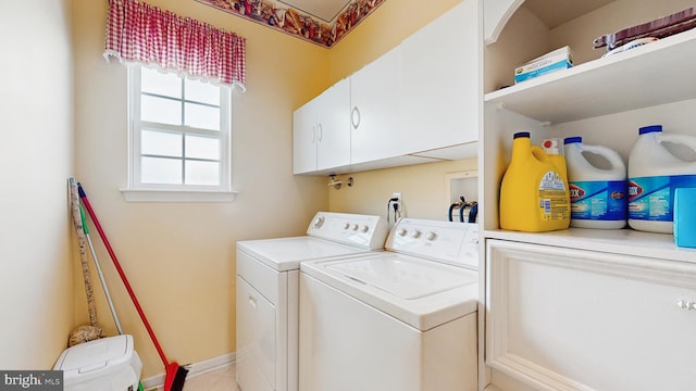 laundry room featuring cabinets and washing machine and dryer