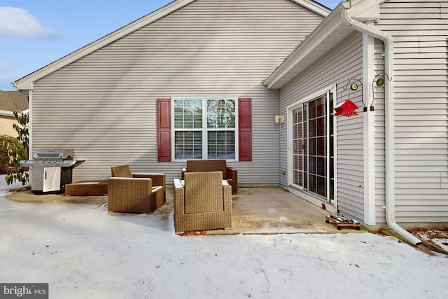 snow covered patio featuring grilling area