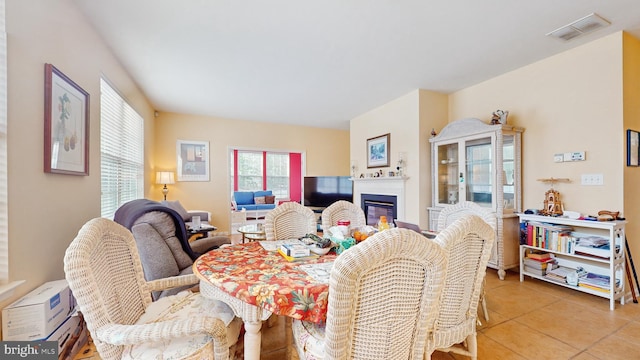 living room featuring tile patterned flooring and a wall unit AC