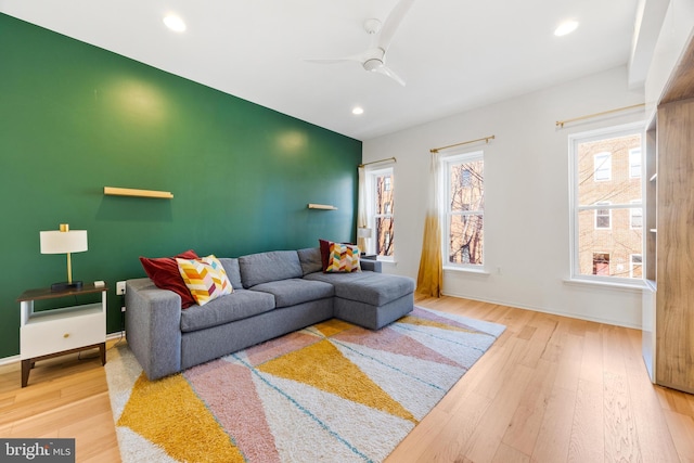 living room with ceiling fan and hardwood / wood-style floors