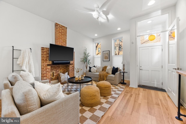 living room with light wood-type flooring and ceiling fan