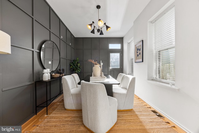 dining space featuring a notable chandelier and light hardwood / wood-style flooring