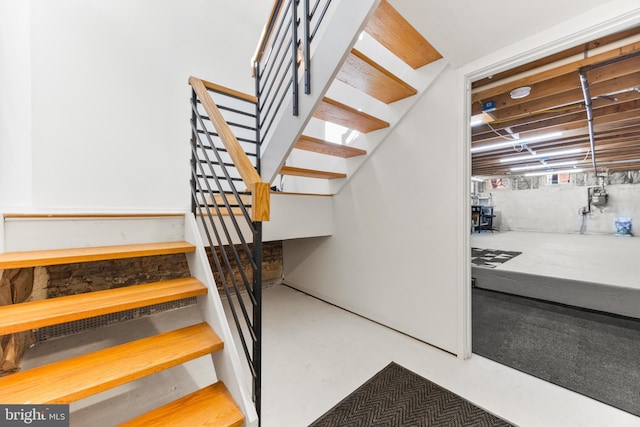 staircase with concrete flooring