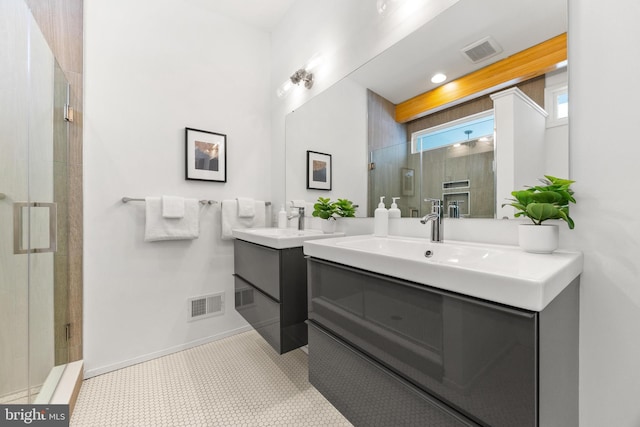 bathroom featuring tile patterned floors, an enclosed shower, and vanity