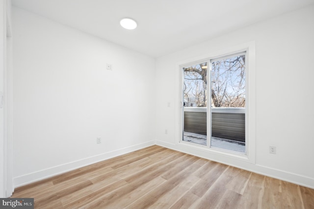 unfurnished room with light hardwood / wood-style flooring